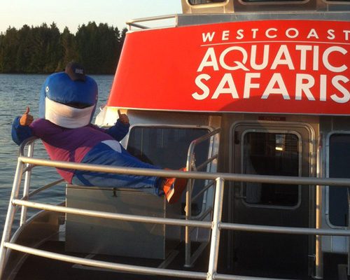 West Coast Aquatic Safaris tour boat with mascot giving thumbs up