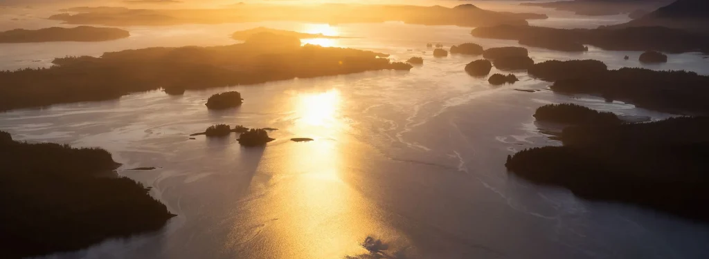 Aerial view of islands and ocean at sunset.