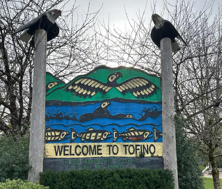 Carved welcome sign for Tofino with birds, seals, and fish.