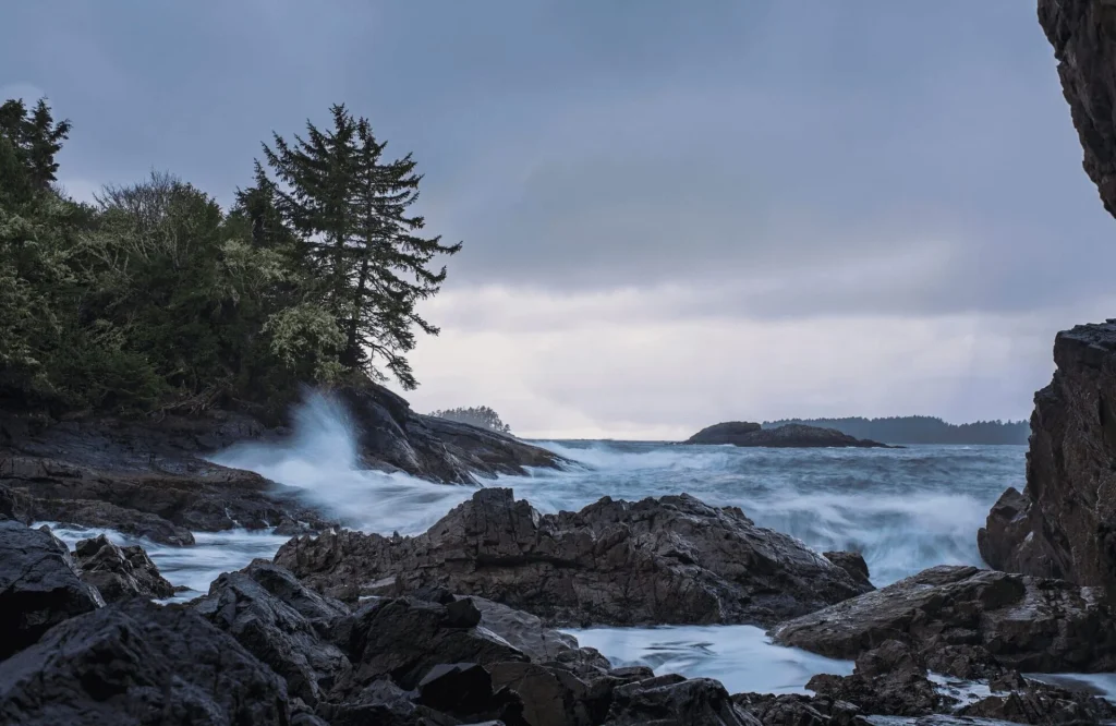 Rocky coastline and ocean waves near a hot springs destination in Tofino